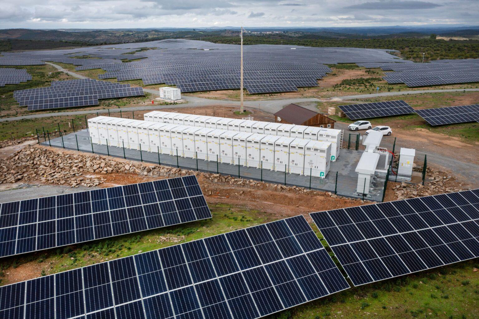 Aerial view of battery energy storage system facility with solar panels